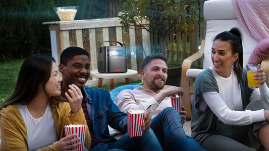 Outdoor movie night with Vision Beam Max projector and friends