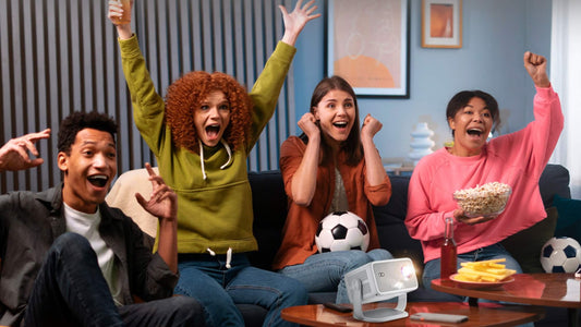Group of friends watching sports on Vision Beam Pro 2 projector, cheering together at home