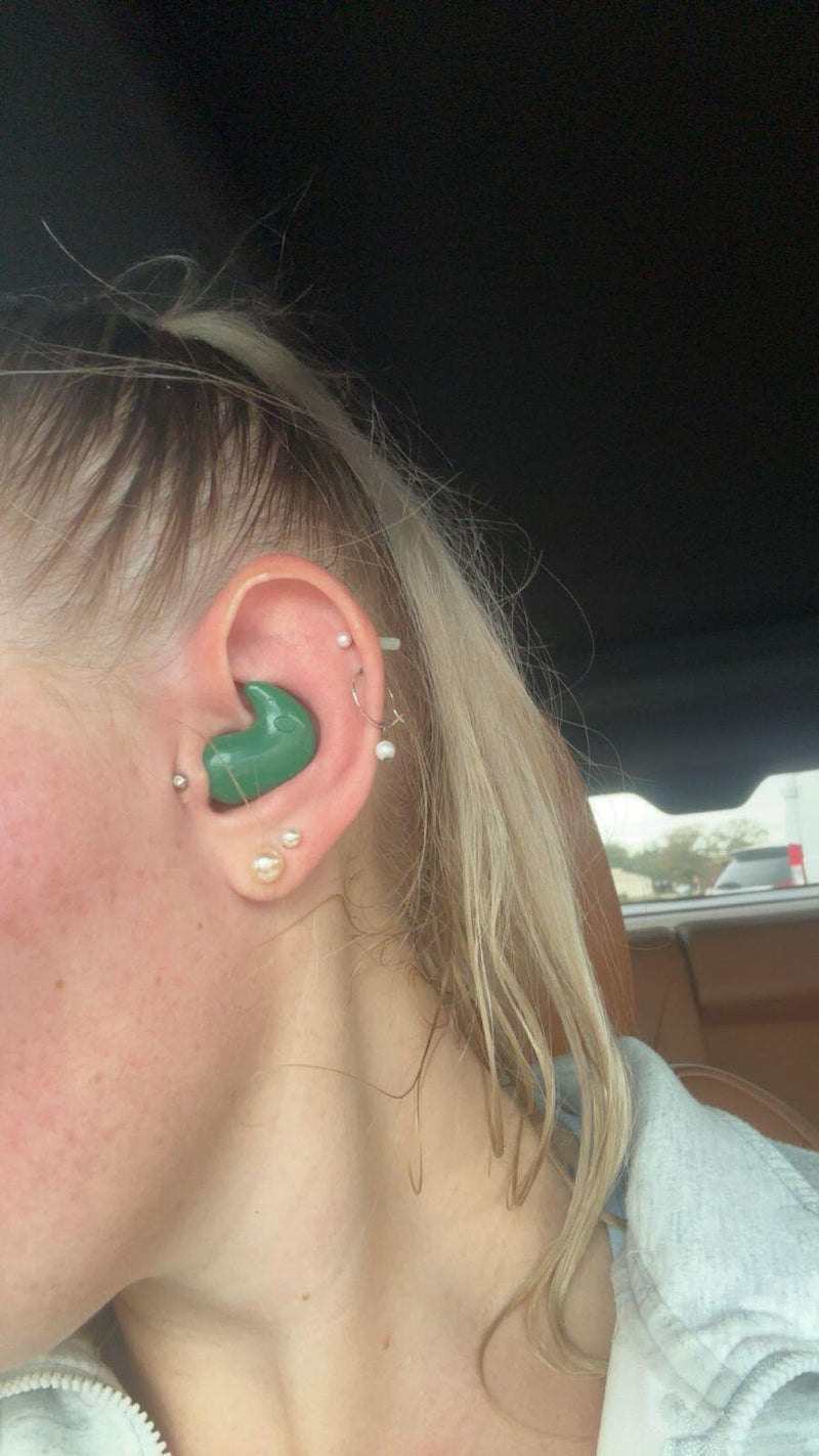 Green ViSound Drift earbud worn in an ear with piercings