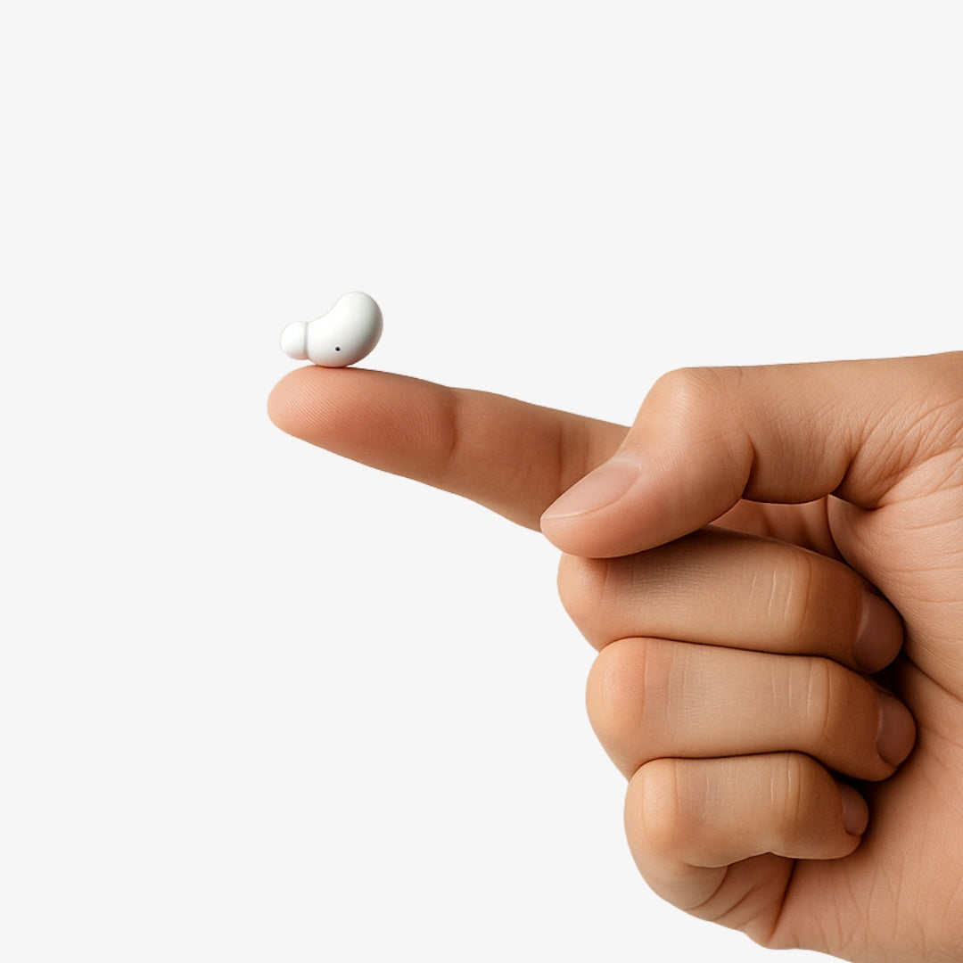 A hand balancing a small white earbud on the fingertip.
