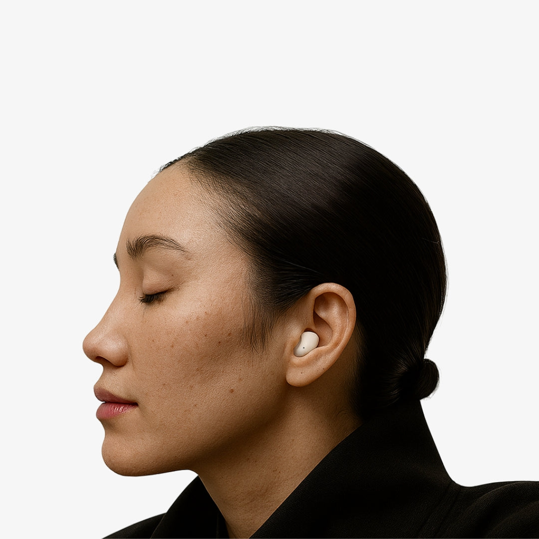 Person with closed eyes wearing wireless earbuds.